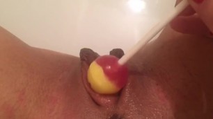 Pretty Woman Masturbates Lollipop with her Clit and Introduces him inside